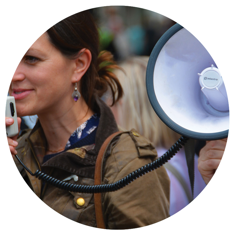 Circular image of a woman holding a megaphone and speaking