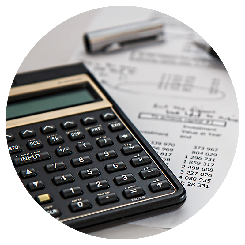 Circular cropped image of a close up calculator and financials sheet below it